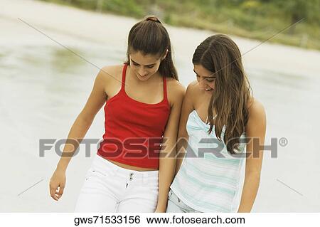 Stock Photograph - Close-up of two girls smiling. Fotosearch