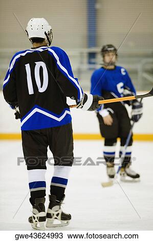 Close-up of two ice hockey players playing ice hockey View Large Photo Image Stock Image - Close-up of two ice hockey players playing ice hockey. Fotosearch