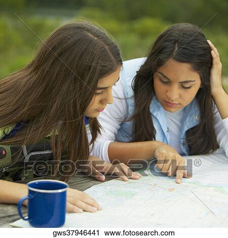 Close-up of two mid adult women looking at a map View Large Photo Image Stock Image - Close-up of two mid adult women looking at a map. Fotosearch