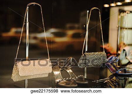 Close-up of two purse with a pair of sandals View Large Photo Image Stock Photo - Close-up of two purse with a pair of sandals. Fotosearch