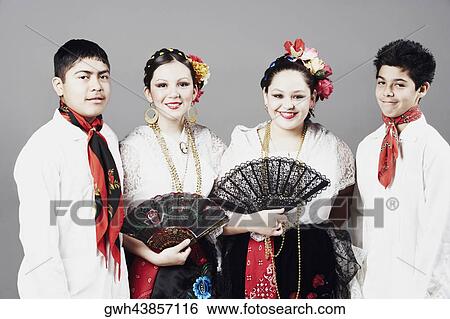 Close-up of two teenage boys and two teenage girls standing together and posing View Large Photo Image Stock Photograph - Close-up of two teenage boys and two teenage girls standing together and posing. Fotosearch