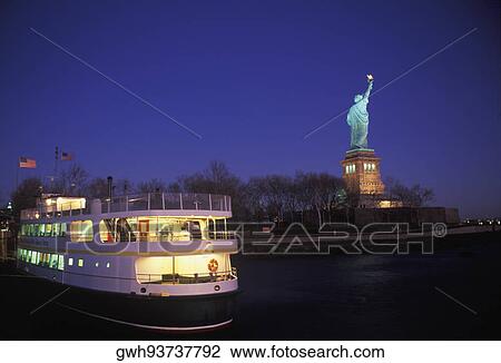 Stock Image - Ferry near a statue, Statue Of Liberty, New York City, New York State, USA. Fotosearch