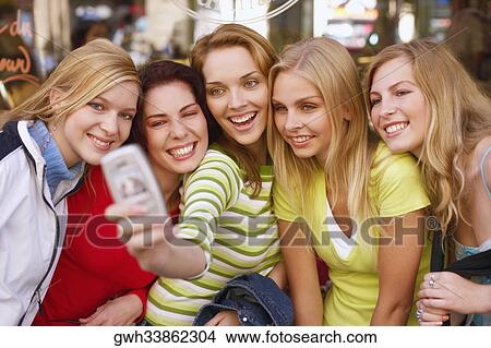 Five young women taking a photograph of themselves View Large Photo Image Picture - Five young women taking a photograph of themselves . Fotosearch