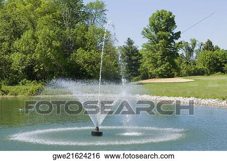Fountain on a golf course View Large Photo Image Stock Photograph - Fountain on a golf course. Fotosearch