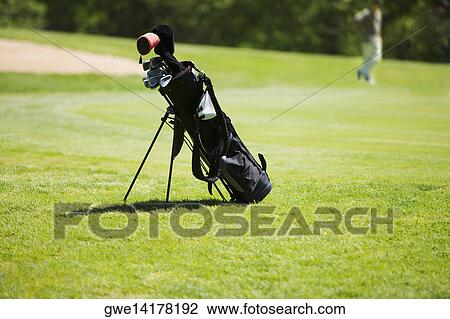 Stock Image - Golf bag on a golf course. Fotosearch