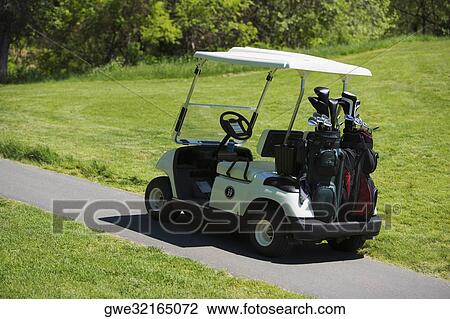Stock Image - Golf cart on a path. Fotosearch