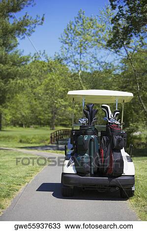 Golf cart on the road View Large Photo Image Stock Image - Golf cart on the road. Fotosearch