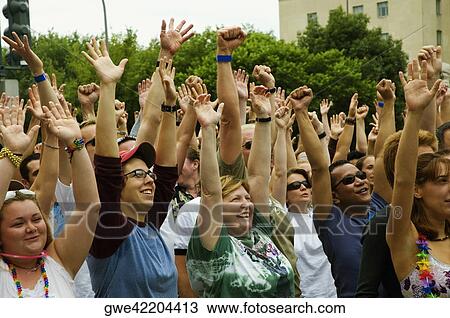 Group of people waving their arms in a gay parade View Large Photo Image Stock Image - Group of people waving their arms in a gay parade. Fotosearch