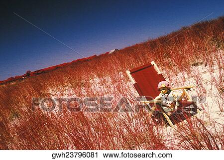 Stock Image - High angle view of a baby girl sitting in an armchair. Fotosearch