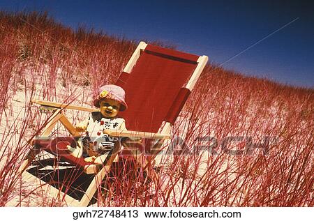 High angle view of a baby girl sitting in an armchair View Large Photo Image Stock Image - High angle view of a baby girl sitting in an armchair. Fotosearch