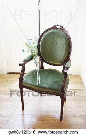 Stock Photograph - High angle view of a bunch of flowers in an armchair. Fotosearch