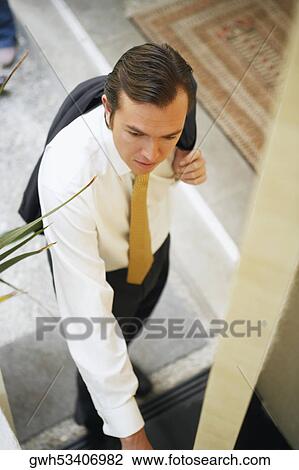 Stock Image - High angle view of a businessman opening a door. Fotosearch