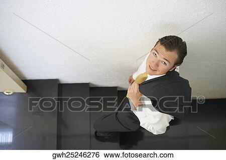 High angle view of a businessman walking up a staircase View Large Photo Image Stock Photograph - High angle view of a businessman walking up a staircase. Fotosearch