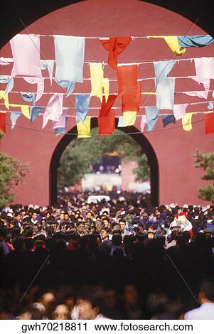Stock Image - High angle view of a crowd of people in an archway, China. Fotosearch
