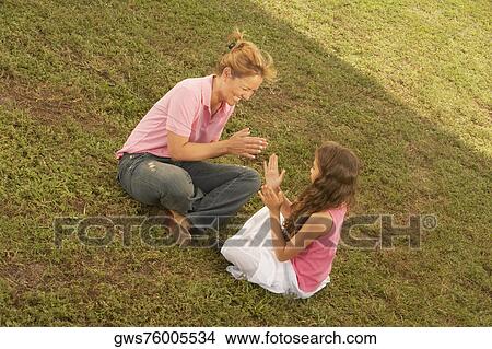 High angle view of a mature woman playing with her daughter in the park View Large Photo Image Picture - High angle view of a mature woman playing with her daughter in the park. Fotosearch