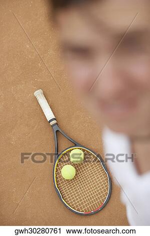 High angle view of a mid adult man with two tennis balls and a tennis racket View Large Photo Image Stock Image - High angle view of a mid adult man with two tennis balls and a tennis racket. Fotosearch