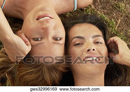High angle view of a mid adult woman with a mature woman lying on the grass View Large Photo Image Stock Photo - High angle view of a mid adult woman with a mature woman lying on the grass. Fotosearch