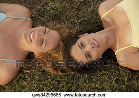 High angle view of a mid adult woman with a mature woman lying on the grass View Large Photo Image Stock Photograph - High angle view of a mid adult woman with a mature woman lying on the grass. Fotosearch