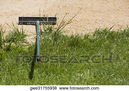 High angle view of a rake on sand View Large Photo Image Stock Photo - High angle view of a rake on sand. Fotosearch