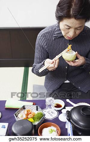 High angle view of a senior woman eating View Large Photo Image Stock Photography - High angle view of a senior woman eating . Fotosearch