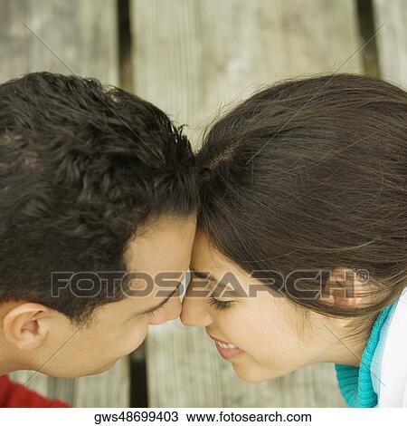 High angle view of a young couple nuzzling View Large Photo Image Stock Image - High angle view of a young couple nuzzling. Fotosearch