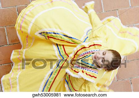 High angle view of a young woman dancing View Large Photo Image Stock Image - High angle view of a young woman dancing. Fotosearch