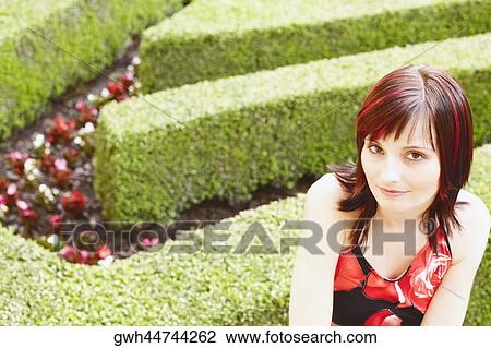 High angle view of a young woman in a garden View Large Photo Image Stock Image - High angle view of a young woman in a garden . Fotosearch