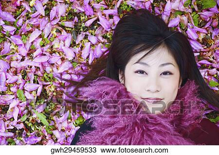 High angle view of a young woman smiling View Large Photo Image Stock Image - High angle view of a young woman smiling. Fotosearch