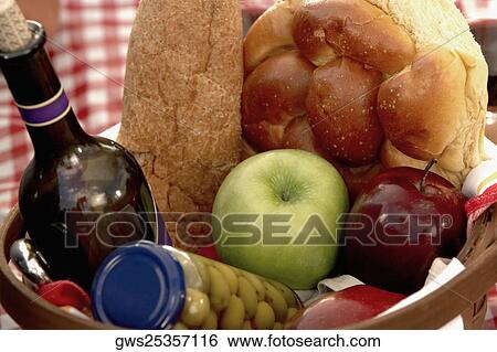 Stock Photograph - High angle view of bottles and buns in a wicker basket. Fotosearch