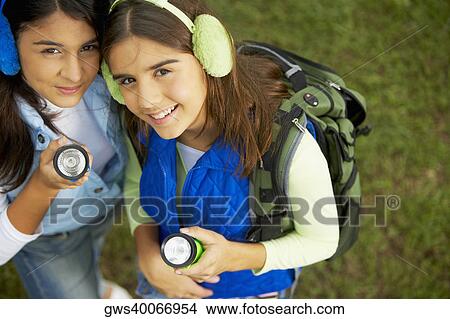 High angle view of two mid adult women holding a flashlight View Large Photo Image Picture - High angle view of two mid adult women holding a flashlight. Fotosearch