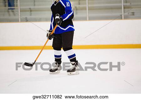 Stock Image - Ice hockey player playing ice hockey. Fotosearch