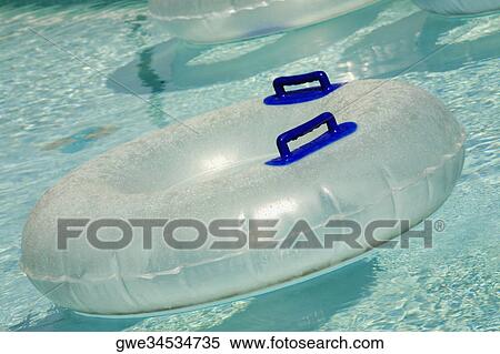 Inflatable rings floating in a pool View Large Photo Image Stock Photography - Inflatable rings floating in a pool. Fotosearch