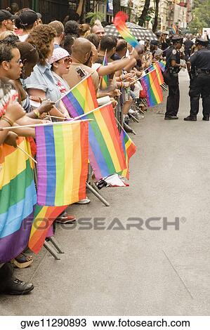 Large group of people holding gay pride flags at a gay parade View Large Photo Image Stock Image - Large group of people holding gay pride flags at a gay parade. Fotosearch