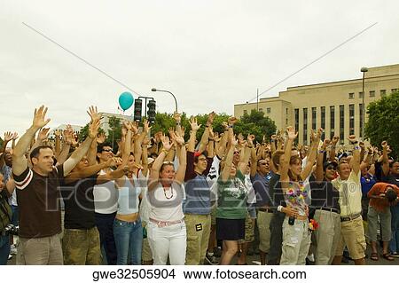 Large group of people waving their arms at a gay parade View Large Photo Image Picture - Large group of people waving their arms at a gay parade. Fotosearch