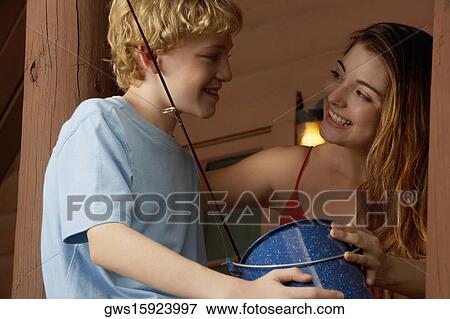 Low angle view of a boy and his sister looking at each other and smiling View Large Photo Image Stock Photo - Low angle view of a boy and his sister looking at each other and smiling. Fotosearch