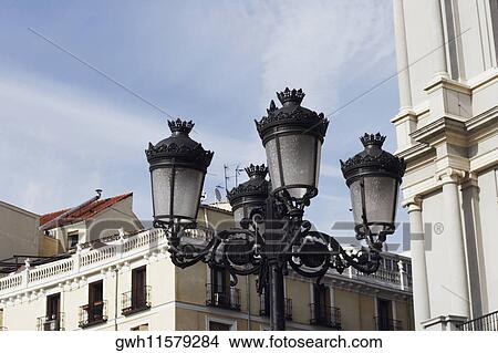 Low angle view of a lamppost in front of a building, Madrid, Spain View Large Photo Image Picture - Low angle view of a lamppost in front of a building, Madrid, Spain. Fotosearch
