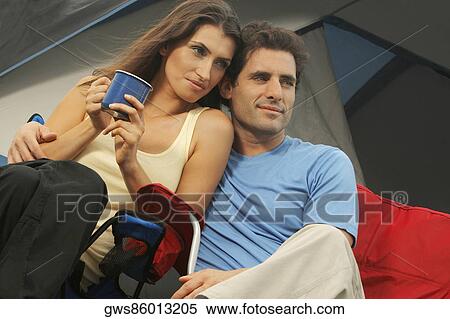 Low angle view of a mid adult couple looking away View Large Photo Image Stock Photography - Low angle view of a mid adult couple looking away. Fotosearch