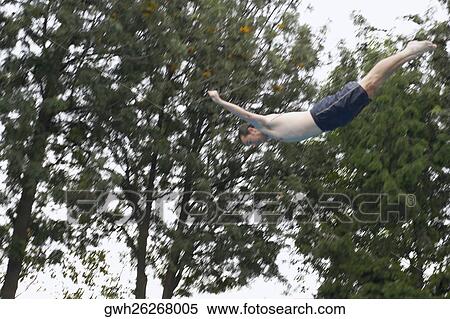 Low angle view of a mid adult man diving View Large Photo Image Stock Photography - Low angle view of a mid adult man diving. Fotosearch