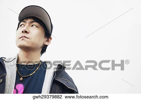 Low angle view of a mid adult man looking away View Large Photo Image Stock Image - Low angle view of a mid adult man looking away. Fotosearch