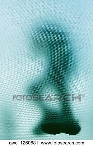 Stock Image - Low angle view of a person on a glass floor. Fotosearch