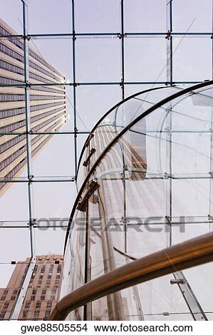 Low angle view of a skyscraper through a glass ceiling View Large Photo Image Picture - Low angle view of a skyscraper through a glass ceiling. Fotosearch