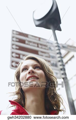Stock Image - Low angle view of a teenage girl smiling . Fotosearch