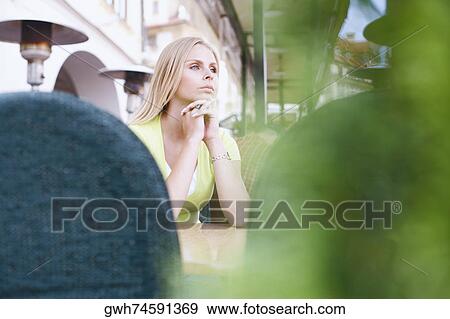 Low angle view of a young woman in a restaurant View Large Photo Image Stock Photo - Low angle view of a young woman in a restaurant . Fotosearch