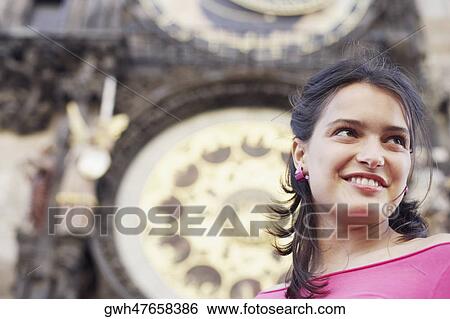 Low angle view of a young woman smiling View Large Photo Image Stock Photograph - Low angle view of a young woman smiling . Fotosearch