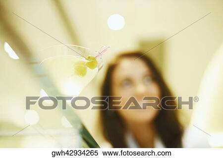 Stock Photography - Low angle view of martini on a glass table. Fotosearch
