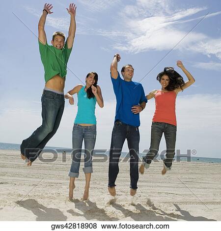 Low angle view of two young couples jumping on the beach and smiling View Large Photo Image Stock Photo - Low angle view of two young couples jumping on the beach and smiling. Fotosearch
