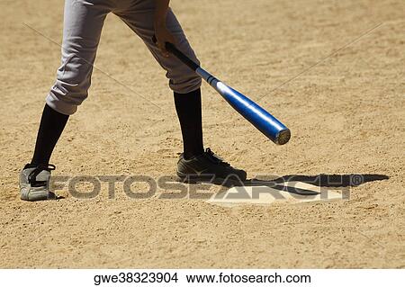 Low section view of a baseball player holding a baseball bat View Large Photo Image Picture - Low section view of a baseball player holding a baseball bat. Fotosearch