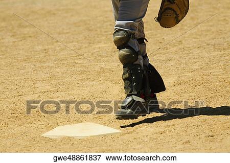 Low section view of a baseball player near a baseball diamond View Large Photo Image Stock Photo - Low section view of a baseball player near a baseball diamond. Fotosearch