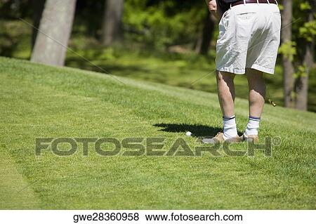 Low section view of a man playing golf on a golf course View Large Photo Image Stock Photo - Low section view of a man playing golf on a golf course. Fotosearch