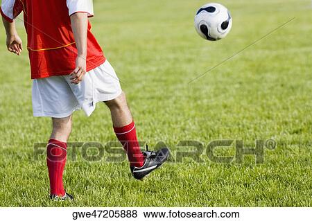 Low section view of a soccer player View Large Photo Image Stock Photo - Low section view of a soccer player. Fotosearch